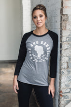 Women wearing a black and grey baseball tee