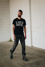 tattooed man wearing a black athletic graphic tee