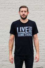 man wearing a black athletic tee and black jeans