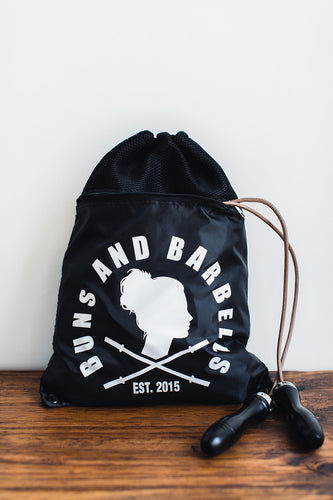 Black drawstring backpack with athletic gear