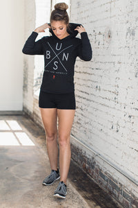 Fit woman styled in a sleek hoodie and black athletic shorts
