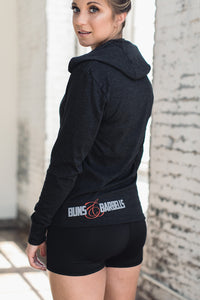 Woman wearing a black hoodie and black athletic shorts