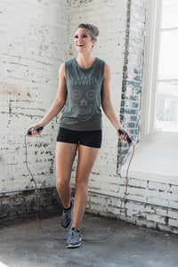 Athletic woman jumping rope while wearing a sugar skull muscle tank