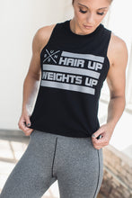 Woman in a black graphic 'Hair up, Weights up', muscle crop tank