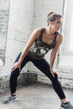 Woman in side lunge while wearing a camo athletic graphic tank