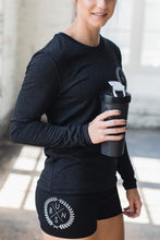 Athlete wearing black graphic shorts with matching long sleeve tee