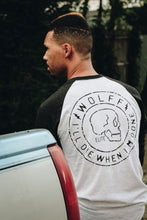 back side of black and white baseball tee with skull graphic design