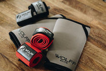 red wrist wraps with grey knee sleeves and a pair of black wrist wraps