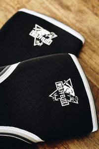 black lifting knee sleeves with a wolf logo