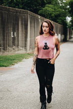woman walking wearing a mauve crop top tank and black jeans