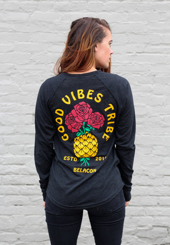woman wearing a long sleeve black shirt with pineapple design that says good vibes