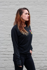 woman with red hair wearing a long sleeve henley shirt