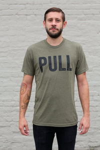 man wearing an olive athletic tee that says pull