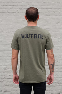 back side of man wearing an olive athletic tee