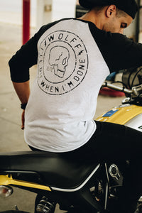 Man on motorcycle wearing a skull graphic baseball tee