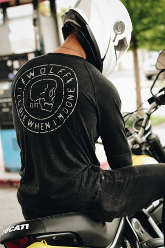 Male motorcyclist wearing a black Henley top with a edgy skull graphic