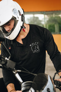 Man wearing a motorcycle helmet and a black henley