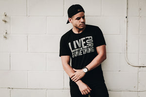 Man wearing a black fitted graphic tee